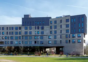 The large, gray exterior of Huo College.