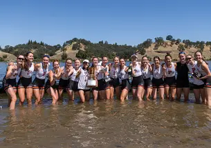 The women&rsquo;s lightweight crew team stands in knee-high water.