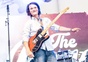 Jeremy Yun &rsquo;25 plays guitar on a stage.