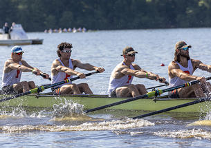 Four rowers from an eight man boat in action at a rowing regatta
