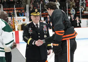 On the ice, Gen. Mark Milley ’80, chair of the Joint Chiefs of Staff, shakes hands with Princeton captain Pito Walton ’23 after the ceremonial puck drop.