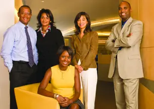 Together for Chicago — and for the presidential campaign of Michelle Obama ’85’s husband — are, from left, John Rogers ’80, Sharon Fairley ’82, Mellody Hobson ’91 (sitting), Kevann Cooke ’82, and Dwight McBride ’90, at the offices of Ari