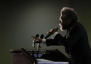 AP_20067788733487.jpg This is a photo of Cornel West, in profile, speaking at a podium.