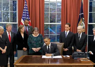 First Response Action board member and legislative liaison Kate Finn ’06, third from left, at the White House as President Obama signs the Kate Puzey Peace Corps Volunteer Protection Act of 2011 into law Nov. 21.