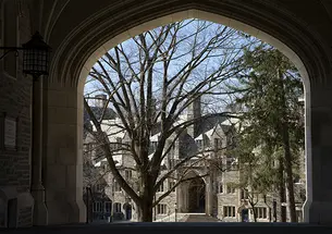 This is a photo of a gothic campus building viewed through an archway.