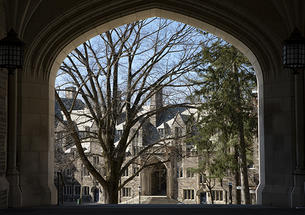 This is a photo of a gothic campus building viewed through an archway.