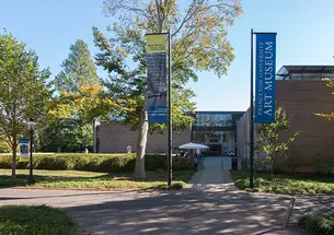 Two flags — one reading Princeton University Art Museum — flank the museum's old entrance.