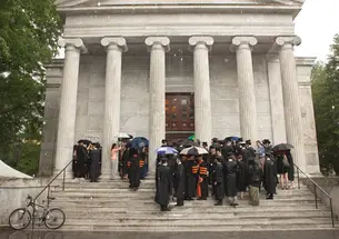 A thunderstorm sent graduate students to Whig Hall to receive their hoods in a short ceremony. The next day, graduate school dean William B. Russel hooded ­students under sunny skies.