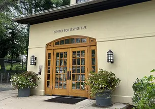 The front doors of Princeton’s Center for Jewish Life, flanked by large planters of flowers.