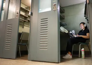 PAW’s Grace Ni ’23 puts a modern spin on the senior thesis process in a 3-by-8 metal carrel. Most carrels were removed in 2012, but three remain available to students at Firestone Library.