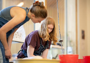 Two women work in the ceramics studio.