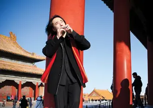 The Ocarina app being played in the Forbidden City in Beijing by its creator, Ge Wang *08, has been downloaded more than 8 million times.
