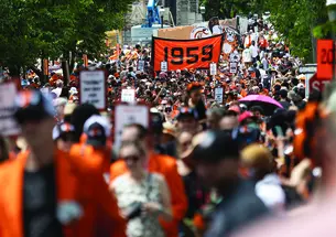 Crowd Kevin Birch.jpg A sign reading 1959 rises above the crowd at the P-rade.