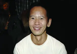 Long Nguyen ’84 wearing a white T-shirt that says PRINCETON in orange letters.