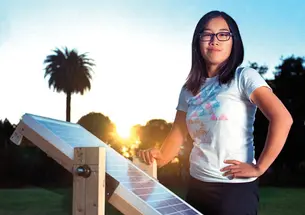 Eden Full ’15 displays a prototype of the SunSaluter in Oakland, Calif., in 2012.