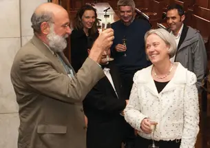 Dean of the Faculty David Dobkin toasts President Tilghman at a faculty meeting.