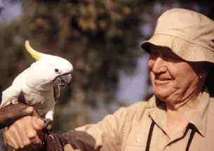 Train meets a white parrot in August 1994, when he was with the World Wildlife Fund.
