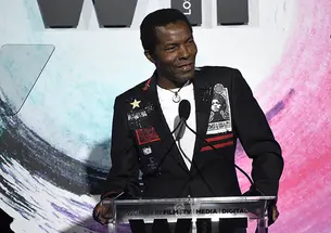 Actor Isaach De Bankolé speaks at a podium.