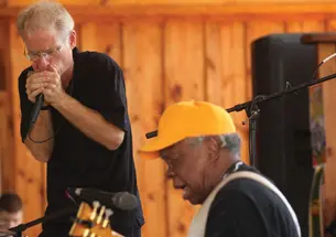 Adam Gussow ’79 *00, left, and his partner in music, Sterling Magee, known as Satan, perform at the Hill Country Harmonica festival in May.