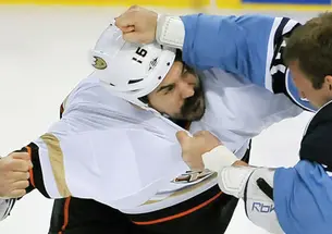 George Parros ’03, left, who plays right wing for the NHL’s Anaheim Ducks, brawls with a Florida Panthers player in February.