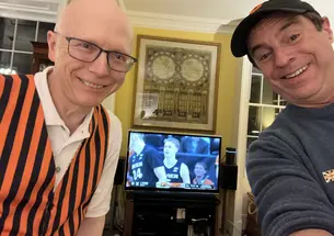 Dean Menegas ’83 and Mark F. Bernstein ’83 form a two-man Princeton watch party early Saturday morning in London.