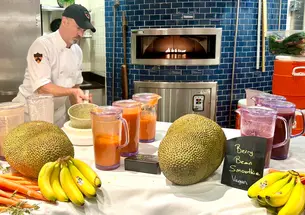 Dining staff prepare vegan berry bean smoothies on a table with bananas and jackfruit.