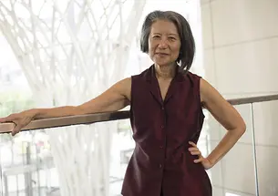 Elizabeth Krist resting her arm on the top of a railing.