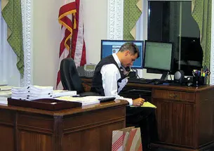 Dressed for a White House party, Alan Krueger works on statistics needed for a 2011 presidential speech.