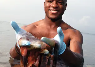 John Dabiri ’01 holds his source of inspiration: a jellyfish.