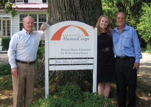  Standing next to the sign introducing Princeton AlumniCorps — formerly Princeton Project 55 — are, from left, president Bill Leahy ’66, executive director Kathleen Reilly, and board chairman Kenly Webster ’55.