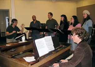 Lisa Scola Prosek '81 rehearses her latest opera, Trap Door, with vocalists.