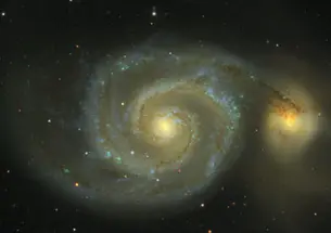 Messier 51, as observed in the Sloan Digital Sky Survey, is actually two galaxies in collision. The impact, which will take 100 million years to complete, creates the spiral arms and the spray of stars visible at the right. Known as the Whirlpool Galaxy, 