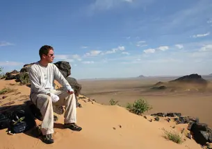 Iain Couzin in Mauritania, where he was studying locusts. His hands are bandged because a toxin from the locusts got on his skin and reacted to sunlight, causing pain.