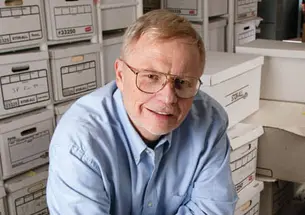 Jeff Perry ’68 in the basement of his home, surrounded by files to be used in his future writing projects.
