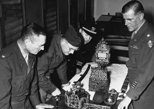 “Monuments Men” examine relics of the Holy Roman regalia upon their return to Vienna in 1946. Lt. Ernest DeWald *14 *16 is at far right, and Lt. Perry Cott ’29 *37 is third from left.
