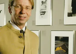James Steward, director of the University Art Museum, in a gallery exhibiting photos from a summer exhibition, “Starburst: Color Photography in America 1970­–1980.”