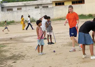 Allison Behringer ’12, a varsity field hockey player, introduced the sport to children at an orphanage in India where she taught during her summer 2010 internship. Below, Alex Banfich ’12 with French pupils at a July 4th celebration.