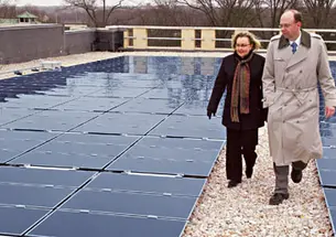 The roof of the Research Collections and Preservation Consortium’s storage library on the Forrestal campus houses the University’s largest solar-energy installation. Shown are Eileen Henthorne, the consortium’s executive director, and Tom Nyquist, P
