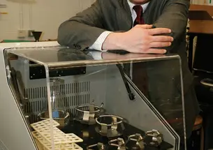Professor Richard Register with an incubator, a common tool in bioengineering.