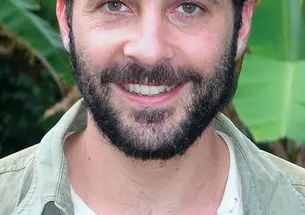 The beetle Deltochilum valgum (below) feeds on millipedes instead of dung – a remarkable adaptation, according to Trond Larsen *06, shown with an emperor tamarin during a recent trip to Peru.