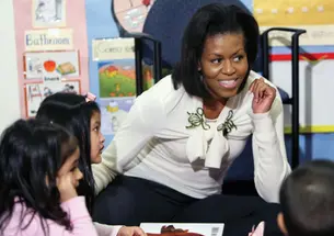 First lady Michelle Obama ’85 listens to children at Mary’s Center, a community social-service center, in Washington in February.