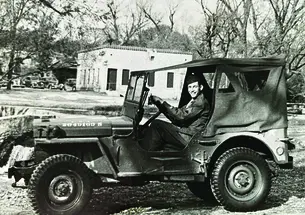 Ernest Stock ’49 driving a Jeep