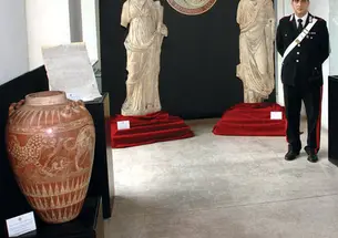 Art objects returned to Italy by American institutions in December were put on display in Rome; the red jar at left appears identical to one given by former antiquities dealer Edoardo Almagià ’73 to the Princeton art museum in 1999.