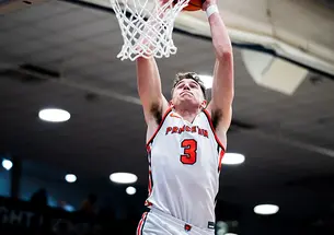 Caden Pierce ’26 rises for a dunk against Brown