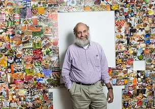 Dean of the Faculty David Dobkin with parts of the Lewis Center exhibition created from his collections.