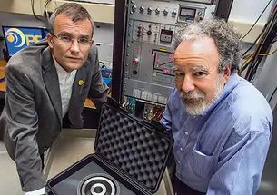 Alexander Glaser, left, and Robert Goldston with a stand-in for a warhead that will be used to test their system for verifying the presence of nuclear warheads.