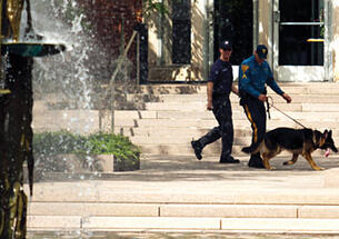 ﻿A search team outside Corwin Hall.