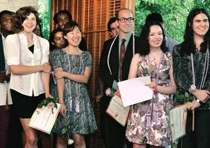 After receiving their lavender honor cords, rainbow ­tassels, certificates, and lavender roses during the LGBT Center’s Lavender Graduation at Prospect House, students smile at the comments of another member of the Class of ’13.