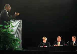 Republican presidential hopeful Herman Cain responds to a question from the Palmetto Freedom Forum’s panelists: from left, ­Professor Robert George, Rep. Steve King, and Sen. Jim DeMint.