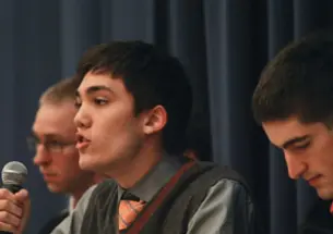 Christian Fong ’14 critiques Occupy Wall Street during a Jan. 13 debate. Listening are Kevin Henneck ’13, left, of the anti-Occupy side and Peter Favaloro ’12, right, of the pro-Occupy team.